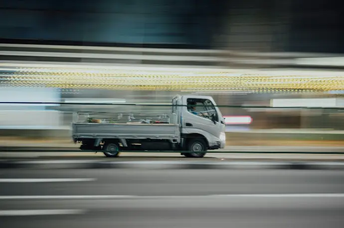 time lapse photography of drop side truck running on road